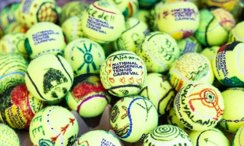 Tennis balls featuring colourful artwork from the National Indigenous Tennis Carnival.